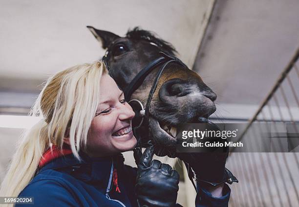 woman and her horse showing teeth. - cavallo equino foto e immagini stock