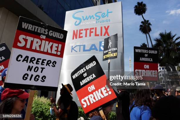 Striking WGA members picket with striking SAG-AFTRA members outside Netflix studios on September 22, 2023 in Los Angeles, California. The Writers...