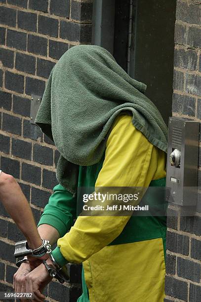 Mark Bridger is taken from Mold Magistrates Court with his head covered on May 29, 2013 in Mold, Wales. The jury has currently been sent home for the...