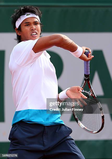 Somdev Devvarman of India plays a forehand in his Men's Singles match against Roger Federer of Switzerland during day four of the French Open at...