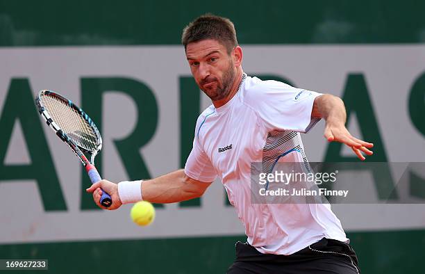 Jan Hajek of Czech Republic plays a forehand in his Men's Singles match against Sam Querry of United States of America during day four of the French...