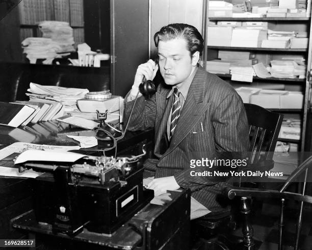 Orson Welles making a phone call the day after his radio broadcast of "The War of the Worlds" which caused many listeners to panic, 31st October 1938.