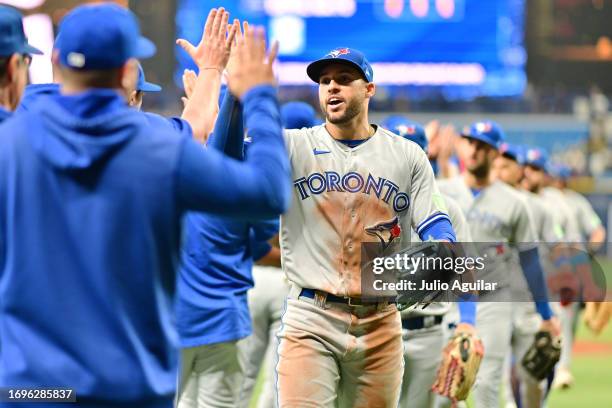 George Springer of the Toronto Blue Jays celebrates with teammates after they defeated the Tampa Bay Rays 6-2 at Tropicana Field on September 22,...