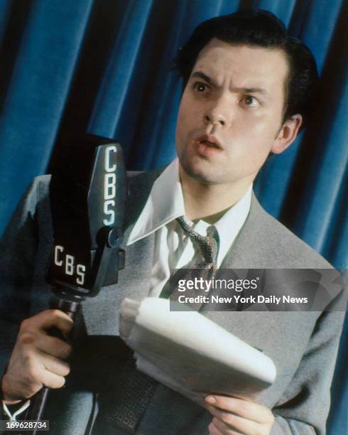 Orson Welles in the Daily News color studio recreating his famous 'The War of the Worlds" broadcast.
