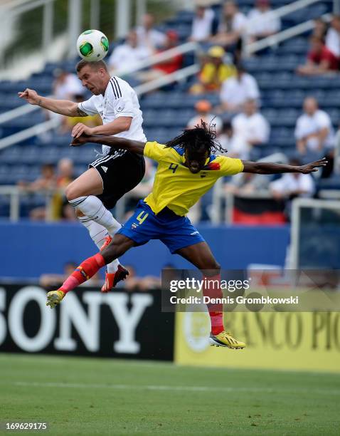 Lukas Podolski of Germany and Juan Carlos Paredes go up for a header during the International Friendly match between Ecuador and Germany at FAU...