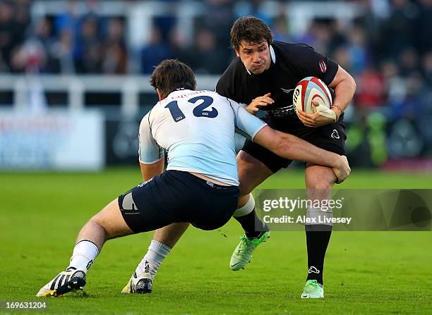 Adam Powell of Newcastle Falcons is tackled by Mark Atkinson of Bedford Blues during the RFU Championship play off final second leg match between...