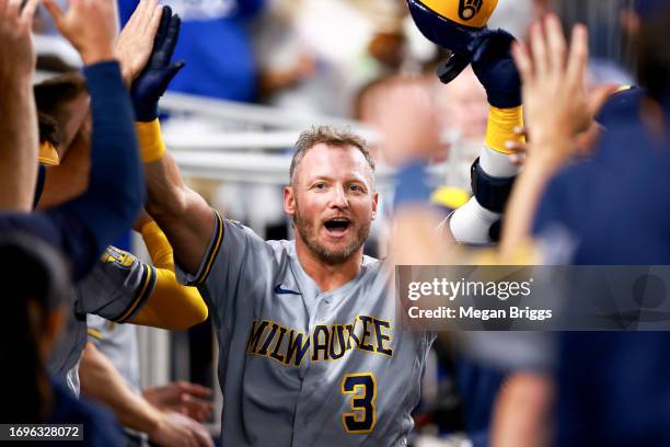Josh Donaldson of the Milwaukee Brewers celebrates with teammates in the dugout during second inning of the game against the Miami Marlins at...