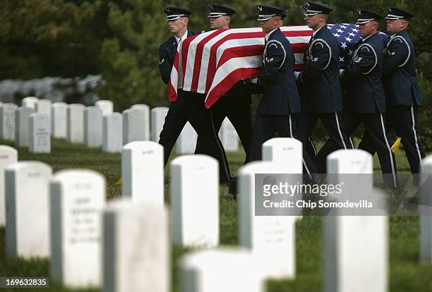 Air Force casket team carries Colonel Ruth Lucas' flag-draped casket to the grave during her full military honors burial service at Arlington...