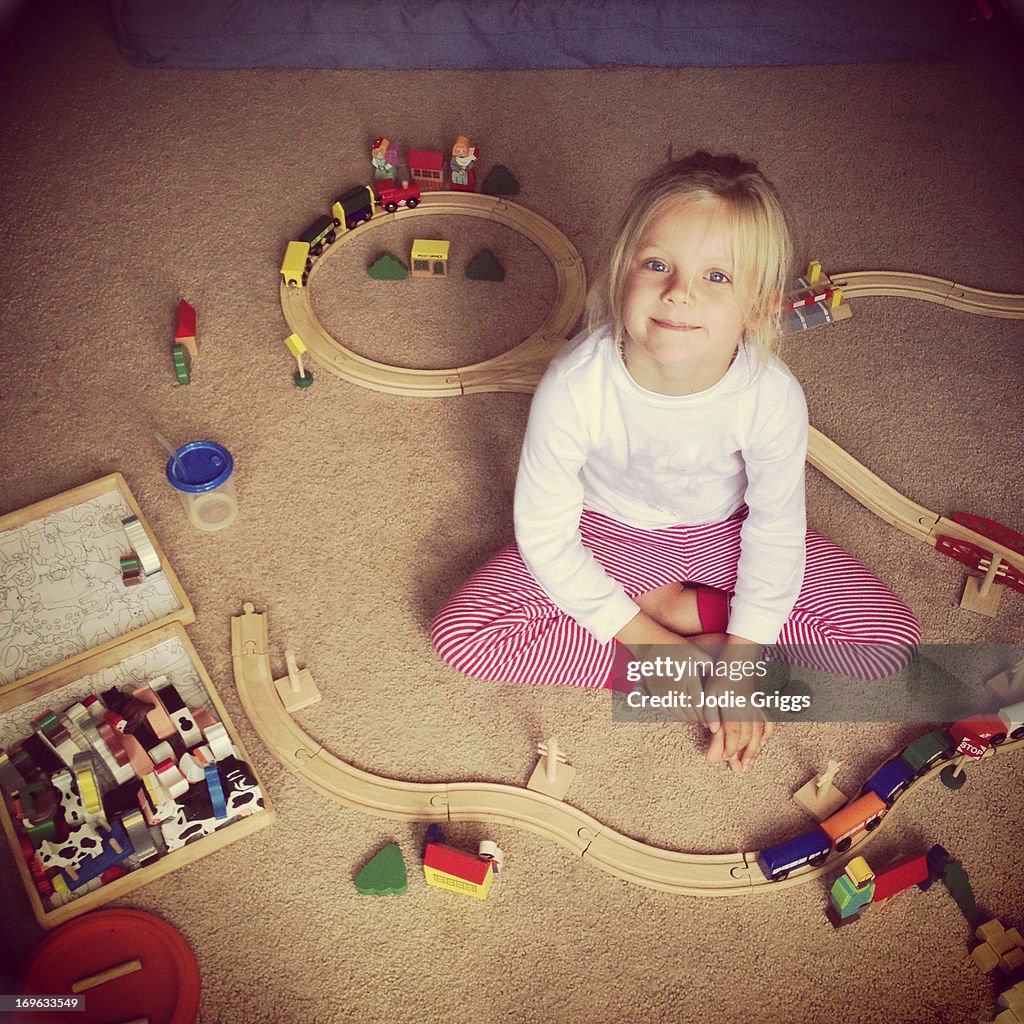 Child playing with wooden train set