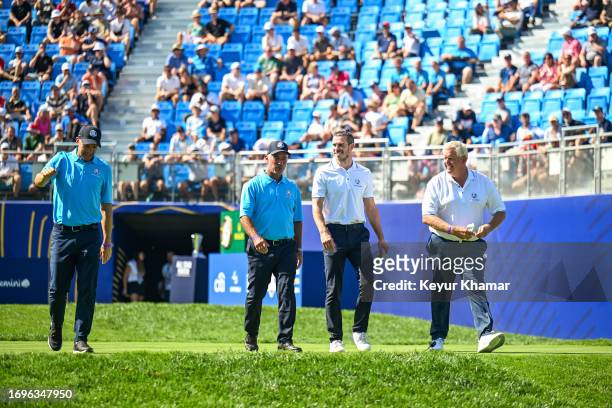 Footballers Gareth Bale and Andriy Shevchenko walk with Corey Pavin and Colin Montgomerie smile as they arrive on the first tee for the All Star...