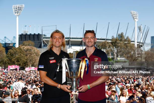 Darcy Moore of the Magpies and Harris Andrews of the Lions hold the Premiership cup during the 2023 AFL Grand Final Parade on September 29, 2023 in...