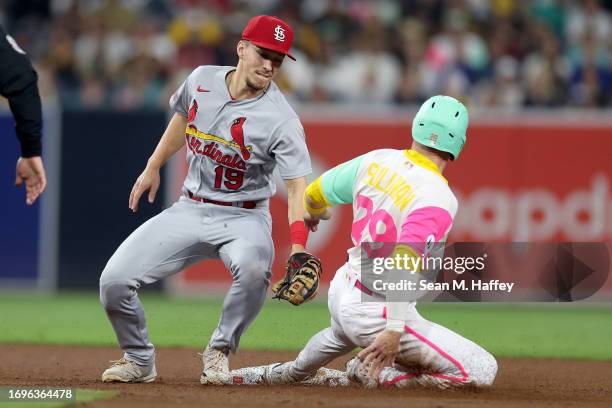 Tommy Edman of the St. Louis Cardinals is late with the tag as Brett Sullivan of the San Diego Padres steals second base during the second inning of...