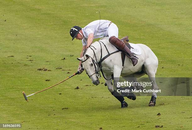 Prince William, Duke of Cambridge almost comes off his horse playing in the Audi Polo Challenge at Chester Racecourse on May 29, 2013 in Chester,...