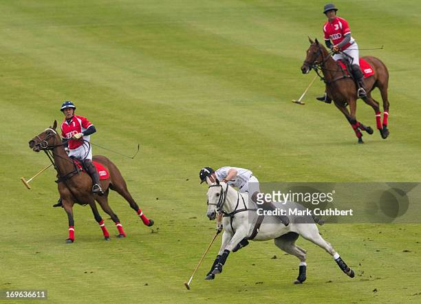 Prince William, Duke of Cambridge almost comes off his horse playing in the Audi Polo Challenge at Chester Racecourse on May 29, 2013 in Chester,...