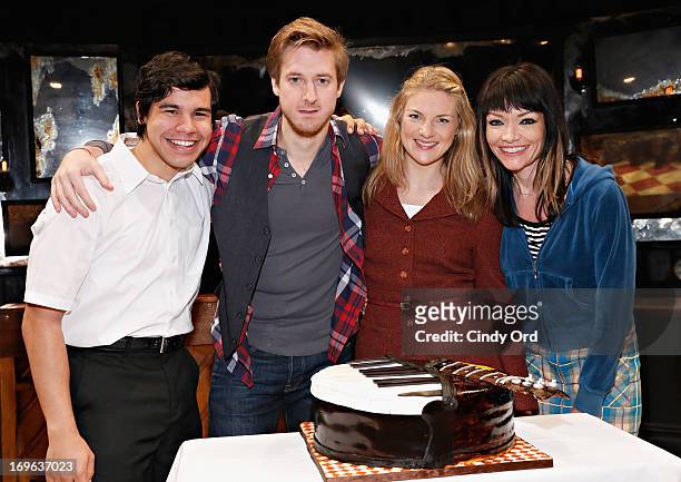 Actors Carlos Valdes, Arthur Darvill, Joanna Christie and Katrina Lenk pose with a cake presented to the cast as "ONCE" on Broadway Celebrates 500...