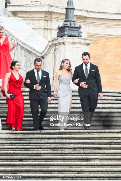 Team members Xander Schauffele, his wife Maya Lowe, Patrick Cantlay and his wife Nikki Guidish arrive for a photo call on the Spanish Steps prior to...