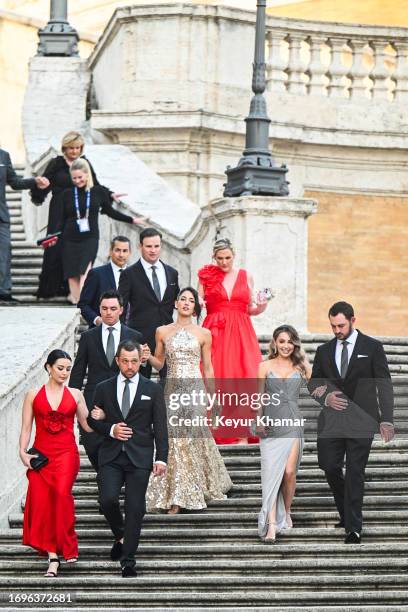 Team members Xander Schauffele, his wife Maya Lowe, Rickie Fowler, his wife Allison Stokke, Patrick Cantlay and his wife Nikki Guidish and Captain...