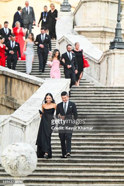 Collin Morikawa of the U.S. Team and his wife Katherine Zhu arrive for a photo call on the Spanish Steps prior to a gala for the 2023 Ryder Cup being...