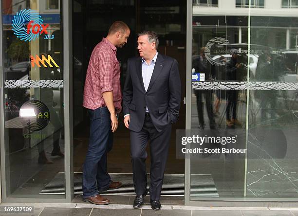 Eddie McGuire walks past Jay Mueller, Executive Producer of the Hot Breakfast Triple M as he arrives to speak to the media outside of the offices of...