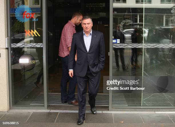 Eddie McGuire walks past Jay Mueller, Executive Producer of the Hot Breakfast Triple M as he arrives to speak to the media outside of the offices of...