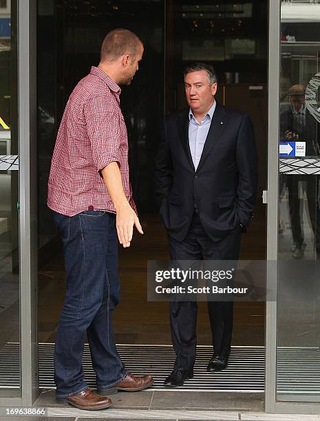 Eddie McGuire walks past Jay Mueller, Executive Producer of the Hot Breakfast Triple M as he arrives to speak to the media outside of the offices of...