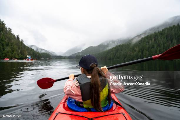 girl sea kayaking - rowing boat stock pictures, royalty-free photos & images