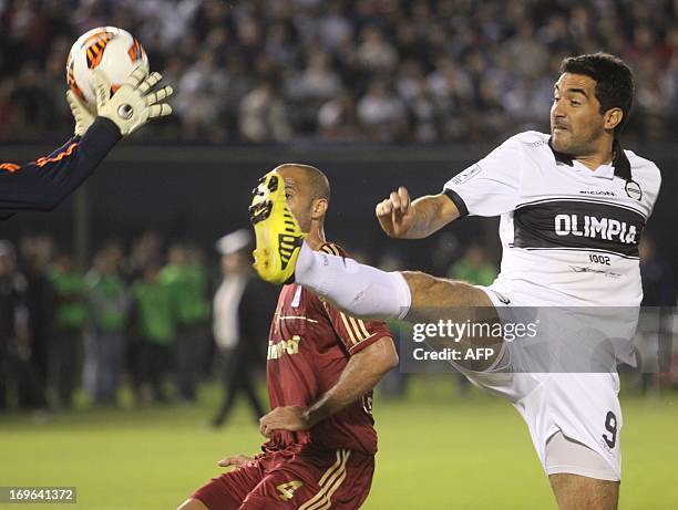 Leandro Euzebio of Brazil’s Fluminense vies for the ball with Juan Carlos Ferreyra of Paraguay' s Olimpia's during their Copa Libertadores football...