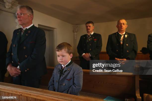 Boy and men dressed in traditional Bavarian folk costumes attend the annual Corpus Christi mass at St. Michael's Church on May 30, 2013 in Seehausen...