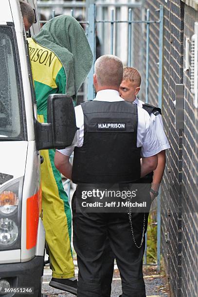 Mark Bridger arrives at Mold Magistrates Court with his head covered on May 30, 2013 in Mold, Wales. The jury will continue deliberations in the...