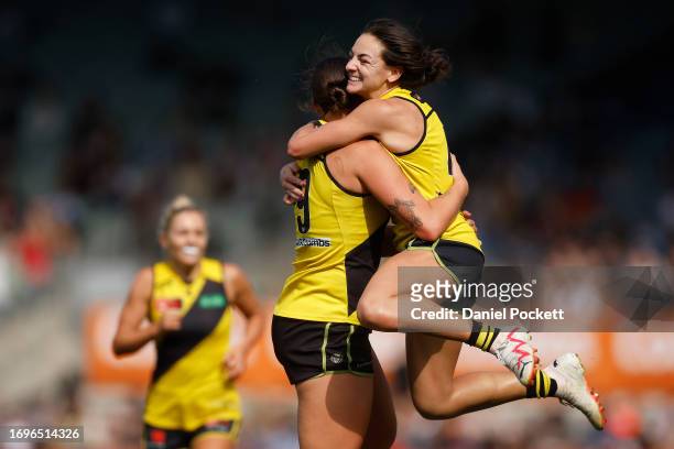 Caitlin Greiser of the Tigers celebrates with Monique Conti of the Tigers after kicking a goal during the round four AFLW match between Carlton Blues...