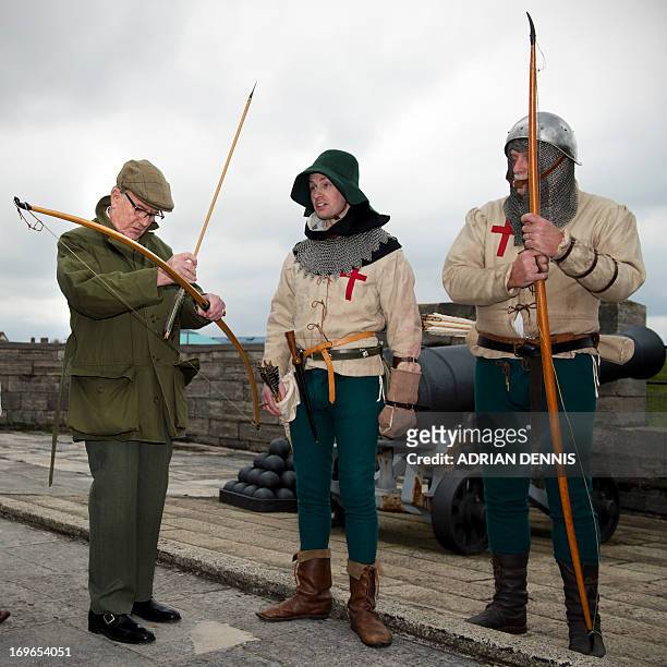 British actor Robert Hardy , a longbow expert, speaks with Purbrook Bowmen after they fired a volley of fire arrows from Southsea Castle into The...