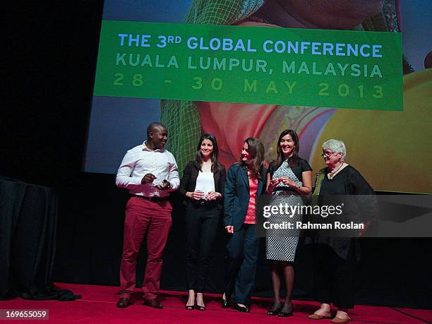 The winners of The Women Deliver Rising Award, Remmy Shawam , Imane Kachari and Pia S.Cayetano pose for a photograph with Co-Chair of Bill & Melinda...