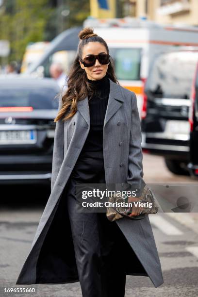 Tamara Kalinic wears grey coat, bag, black dress outside Gucci during the Milan Fashion Week - Womenswear Spring/Summer 2024 on September 22, 2023 in...