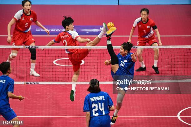 Thailand's Wassana Soiraya kicks the ball as South Korea's Kim Seyoung defends in the final match for gold medal of the women's team sepak takraw...