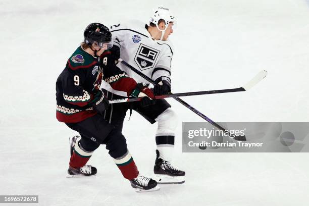 Clayton Keller of the Arizona Coyotes competes with Trevor Moore of the LA Kings during the NHL Global Series match between Arizona Coyotes and Los...