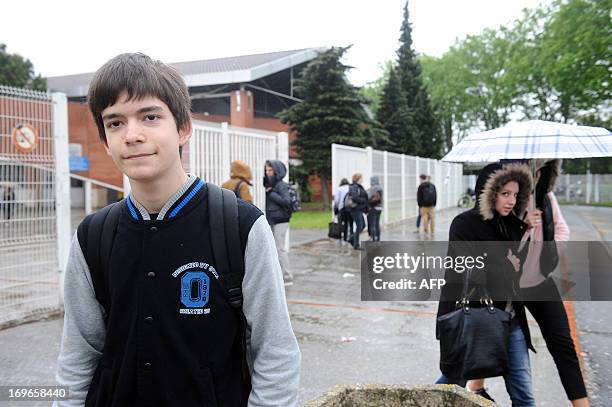 Maxime Parra poses in front of his high school in Saint-Orens-de-Gameville, southern France, on May 22, 2013. Maxime is one of the youngest students...