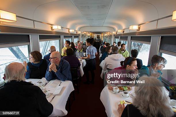 Passengers aboard the Canadian, a Via Rail train from Toronto to Vancouver, peer out both sides of the dining car to see the sites while still in...
