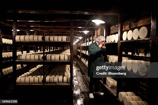 Bernard Roques, a technician, tests a sample of maturing Roquefort Societe 150years cheese in caves at the Lebrou-Roquefort plant, part of Groupe...