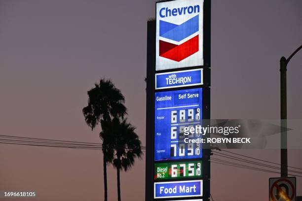 Gas prices are seen at a Chevron gas station in Los Angeles on September 28, 2023. California gas prices are nearing USD $7 per gallon in some...