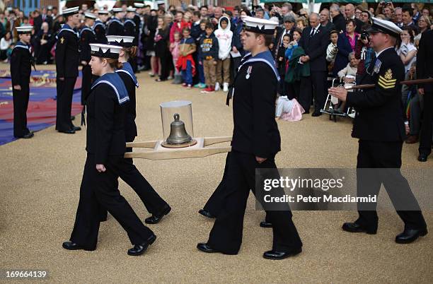 Crew members from HMS Duncan carry the original ships bell to the The Mary Rose Museum during the opening ceremony on May 30, 2013 in the Solent off...