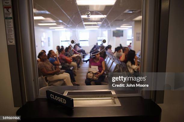 Immigrants await their turn for green card and citizenship interviews at the U.S. Citizenship and Immigration Services Queens office on May 30, 2013...