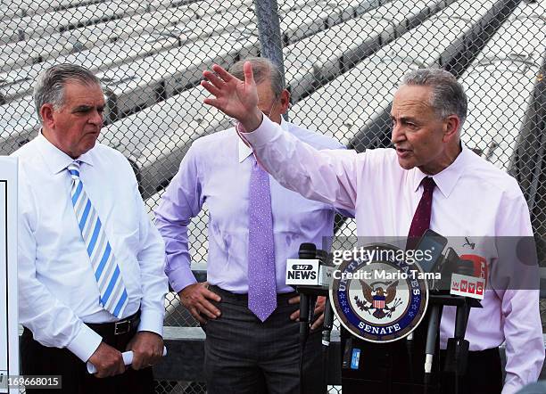 Sen. Charles Schumer speaks as U.S. Transportation Secretary Ray LaHood looks on at a news conference at the Hudson Yards site in Manhattan on May...