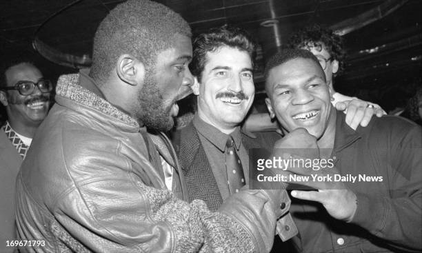 Coming up Rose Bowl for Giant Lawrence Taylor and buddies Keith Hernandez and Mike Tyson as they go into a huddle at postgame victory celebration...