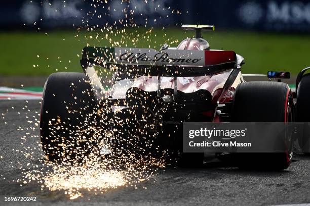 Sparks fly from the rear of Zhou Guanyu of China driving the Alfa Romeo F1 C43 Ferrari on track during qualifying ahead of the F1 Grand Prix of Japan...