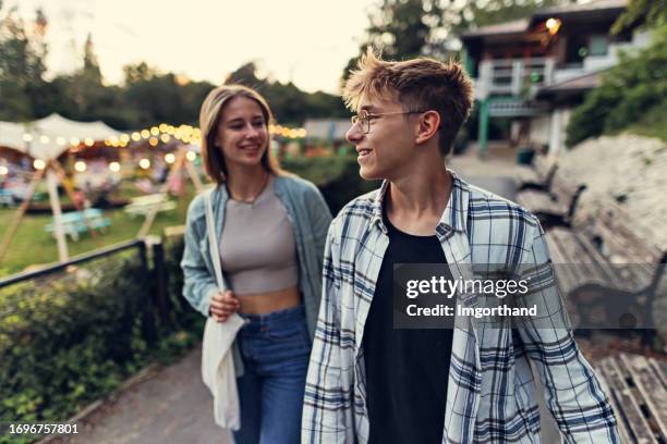 teenagers enjoying walking in the public park in bath, somerset, united kingdom. - boy and girl talking stock pictures, royalty-free photos & images