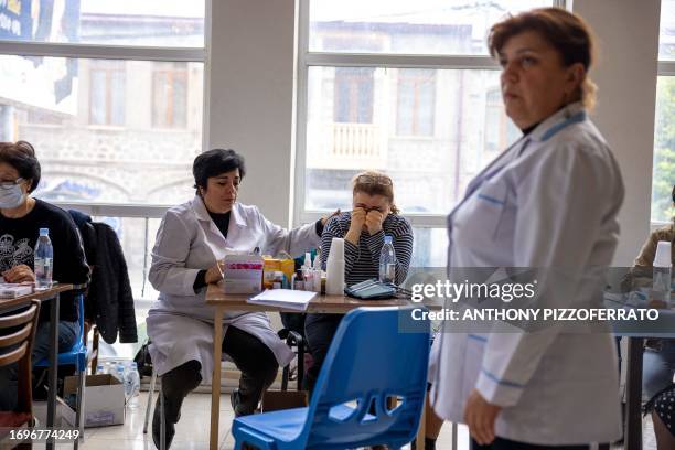 Goris, Armenia. Newly arrived refugees from Nagorno Karabakh processing in the Goris reigstration center.Many are also using the time at the location...
