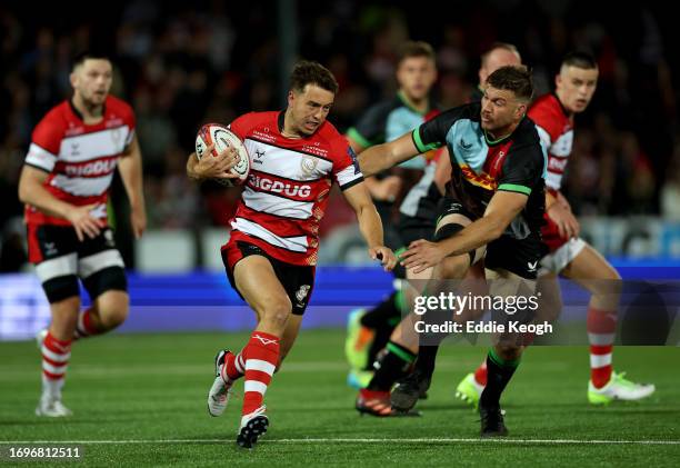 Lloyd Evans of Gloucester Rugby runs past Stephan Lewies of Harlequins during their Premiership Rugby Cup match at Kingsholm Stadium on September 22,...