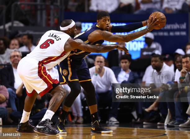 Paul George of the Indiana Pacers handles the ball against LeBron James of the Miami Heat in the first quarter during Game Five of the Eastern...