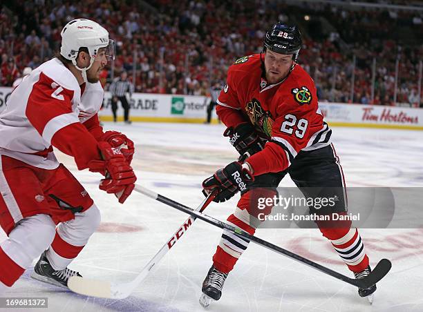 Bryan Bickell of the Chicago Blackhawks passes around Brendan Smith of the Detroit Red Wings in Game Seven of the Western Conference Semifinals...