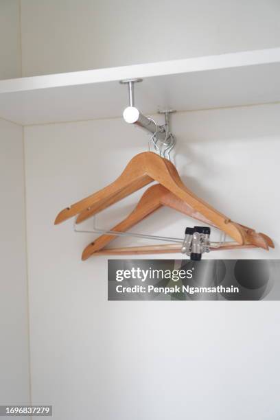 clothes hanger on stainless steel rail in the closet - steel railings stock pictures, royalty-free photos & images